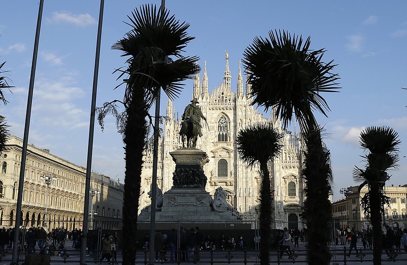 
              Palm trees are planted in flowerbed in front of Milan's gothic-era Duomo Cathedral, Italy, Friday, Feb. 17, 2017. The appearance of a palm-filled oasis opposite the Duomo has spawned a vibrant public debate ranging from the ironic to the xenophobic. (AP Photo/Antonio Calanni)
            