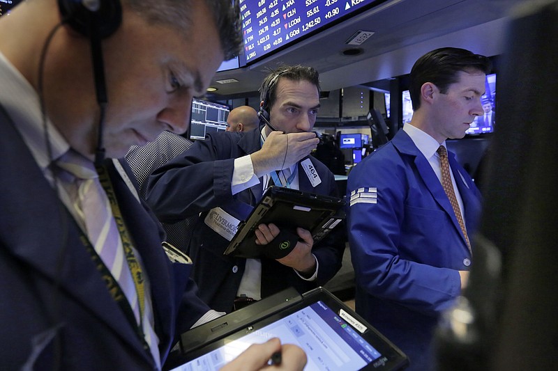 
              Trader Gregory Rowe, center, works on the floor of the New York Stock Exchange, Friday, Feb. 17, 2017. Stocks are posting moderate declines in early trading as a fast-paced market rally of the past two weeks goes into reverse. (AP Photo/Richard Drew)
            