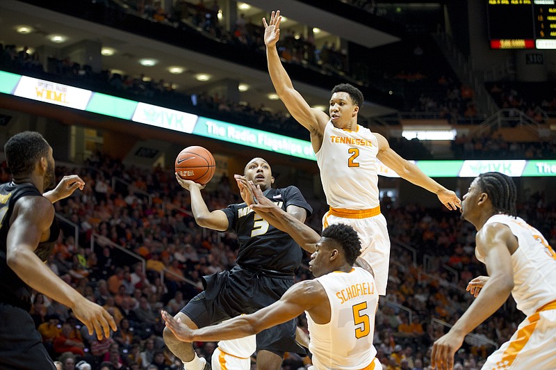 Tennessee's Grant Williams (2) and Tennessee's Admiral Schofield (5) defend against Missouri's Mitchell Kemp (5) as he goes for a shot during an NCAA college basketball game at Thompson-Boling Arena in Knoxville, Tenn., on Saturday, Feb 18, 2017. Tennessee won 90-70. (Calvin Mattheis/Knoxville News Sentinel via AP)