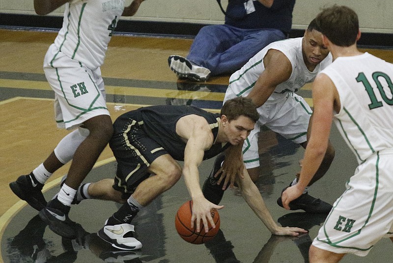 Bradley Central's John Brown falls on a loose ball ahead of East Hamilton's Justin Dozier, right, during their TSSAA District 5-AAA basketball tournament game at Soddy-Daisy High School on Saturday, Feb. 18, 2017, in Soddy-Daisy, Tenn.