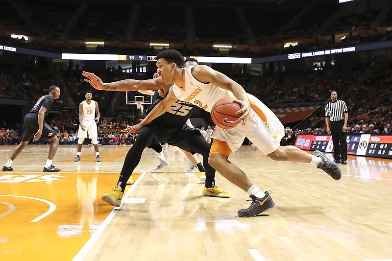 Tennessee's Grant Williams drives to the basket against Missouri's Russell Woods in the first half of the NCAA basketball game between the Vols and Tigers in Knoxville on Feb. 18, 2017. Tennessee won 90-70. (Photo By Craig Bisacre/Tennessee Athletics)