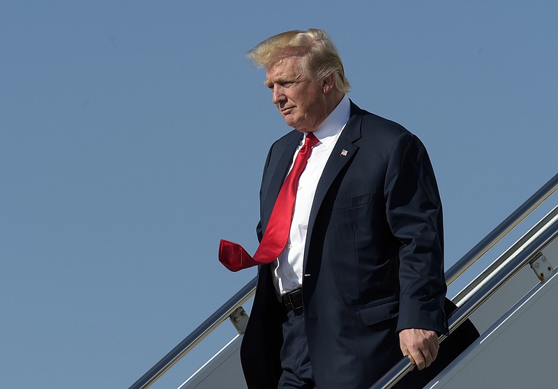 
              President Donald Trump walks down the steps of Air Force One as he arrives a Palm Beach International Airport in West Palm Beach, Fla., Friday, Feb. 17, 2017. Trump is spending a third weekend in a row at his Mar-a-Lago estate. (AP Photo/Susan Walsh)
            