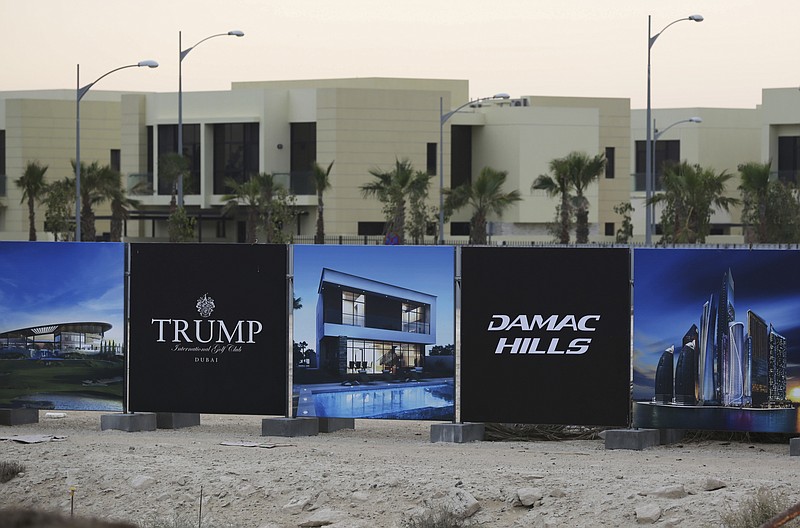 
              FILE- In this Sunday, Feb. 12, 2017 file photo, a new sign sits on display for the Trump International Golf Club in Dubai, United Arab Emirates. U.S. President Donald Trump's two sons in charge of his business empire will attend a closed-door event to mark the opening of the Trump International Golf Club in Dubai. (AP Photo/Jon Gambrell, File)
            