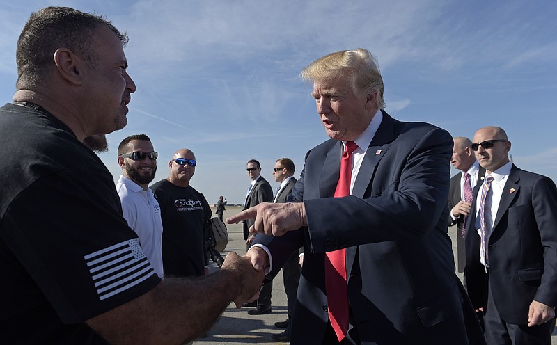 
              President Donald Trump greets people after he arrived at Palm Beach International Airport in West Palm Beach, Fla., Friday, Feb. 17, 2017. Trump is spending a third weekend in a row at his Mar-a-Lago estate. (AP Photo/Susan Walsh)
            