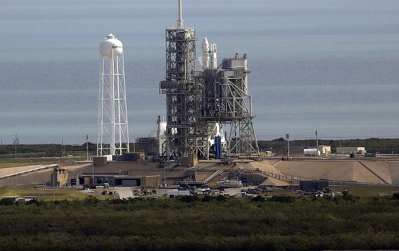
              A Space X Falcon9 rocket sits on the launch pad, Saturday, Feb. 18, 2017 at the Kennedy Space Center in Cape Canaveral, Fla   Last-minute rocket trouble forced SpaceX on Saturday to delay its inaugural launch from NASA's historic moon pad. SpaceX halted the countdown with just 13 seconds remaining. The problem with the second-stage thrust control actually cropped up several minutes earlier. With just a single second to get the Falcon rocket airborne, flight controllers could not resolve the issue in time.  (Red Huber/Orlando Sentinel via AP)
            