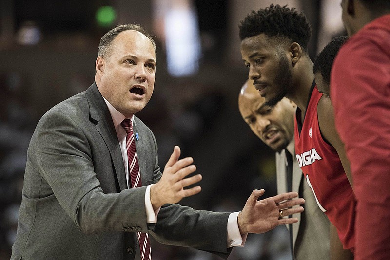 Georgia men's basketball coach Mark Fox talks with players during the Bulldogs' game at South Carolina this month.