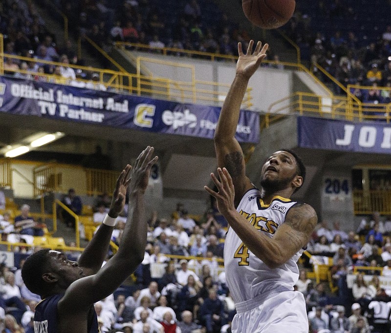UTC guard Johnathan Burroughs-Cook shoots over ETSU guard A.J. Merriweather during the Mocs' basketball game against the ETSU Buccaneers at McKenzie Arena on Saturday, Feb. 18, 2017, in Chattanooga, Tenn. UTC fell to 10-5 in the SoCon following their 65-51 loss to ETSU.