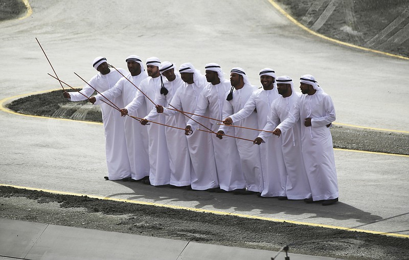 
              Emirati men take part in a traditional cane dance at the start of the International Defense Exhibition and Conference, known by the acronym IDEX, in Abu Dhabi, United Arab Emirates, Sunday, Feb. 19, 2017. (AP Photo/Jon Gambrell)
            