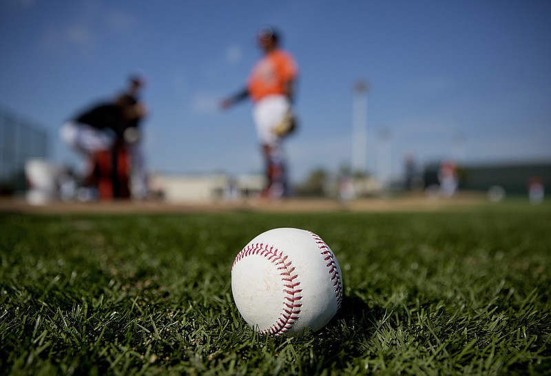 
              A ball sits on the field as Baltimore Orioles players work out during baseball spring training in Sarasota, Fla., Wednesday, Feb. 15, 2017. (AP Photo/David Goldman)
            