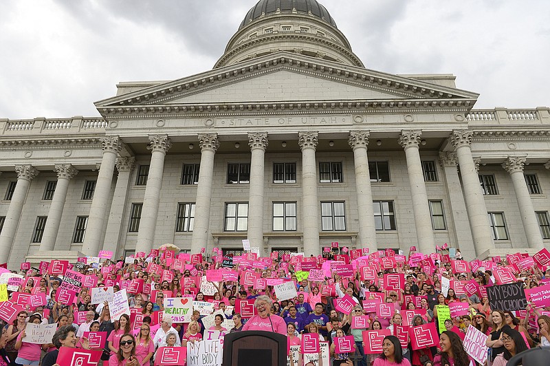 
              FILE - This Aug. 25, 2015, file photo, Karrie Galloway, CEO of Planned Parenthood Action Council, laughs as the roar of the crowd drowns out her speech at the state Capitol in Salt Lake City. Galloway says her doctors are trying to comply with the law, but there is no clear guidance in the law or from state officials on how to do so. (Leah Hogsten/The Salt Lake Tribune via AP, File)
            