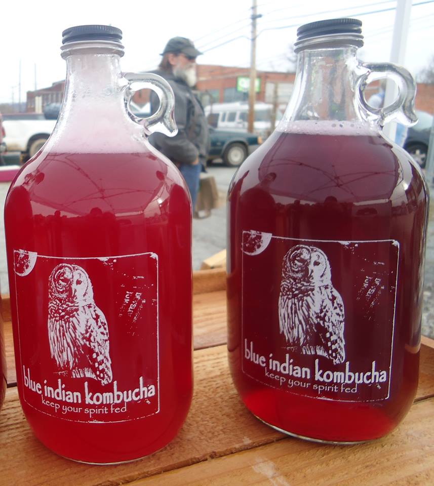 Blue Indian Kombucha growlers filled with blackberry sage and blueberry ginger kombucha.