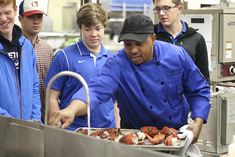 Chef Willie Dabbs teaches students how boil lobster during the MasterChef class.