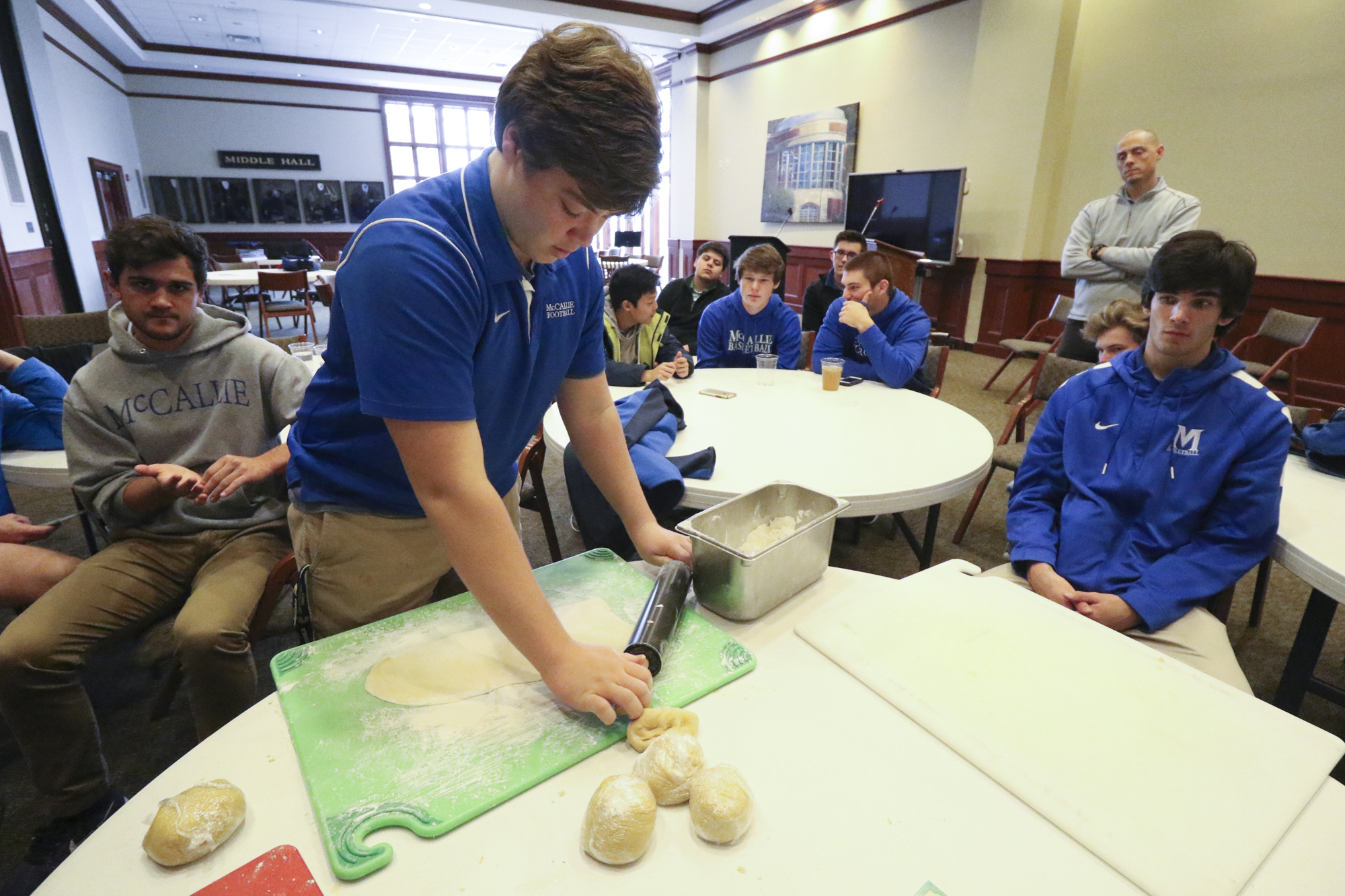 Will Stanley rolls out fresh dough to make fettuccine noodles.