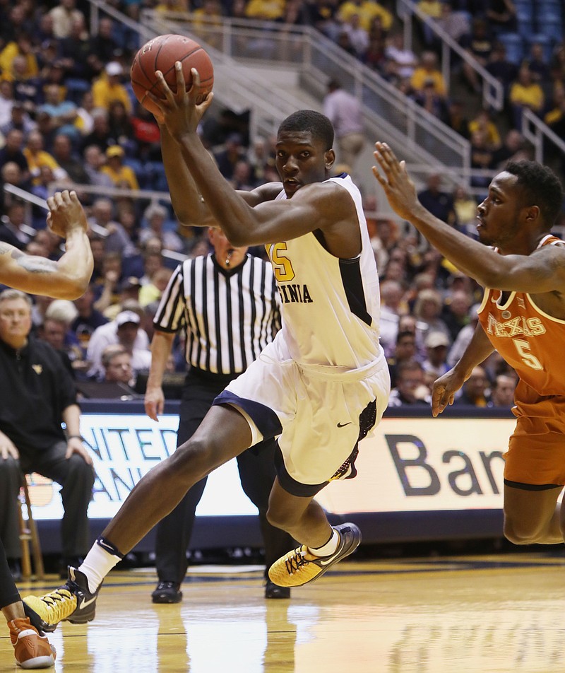 
              West Virginia forward Lamont West (15) drives to the basket while being guarded by Texas guard Kendal Yancy (5) during the second half of an NCAA college basketball game, Monday, Feb. 20, 2017, in Morgantown, W.Va. (AP Photo/Raymond Thompson)
            