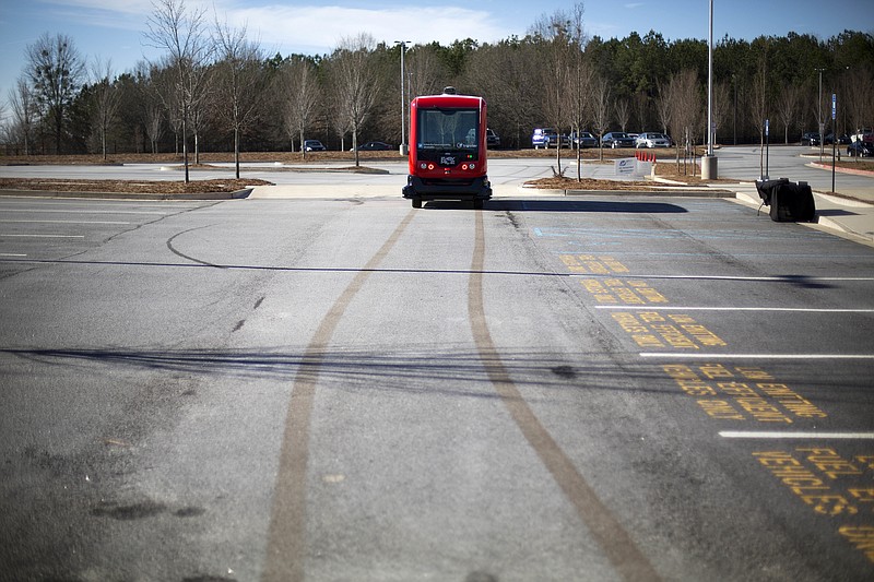 
              In this Thursday, Jan. 26, 2017 photo, a driverless shuttle bus retraces its tracks while on display at the Riverside EpiCenter in Austell, Ga. Self-driving vehicles could begin tooling down a bustling Atlanta street full of cars, buses, bicyclists and college students, as the city vies with other communities nationwide to test the emerging technology. (AP Photo/David Goldman)
            