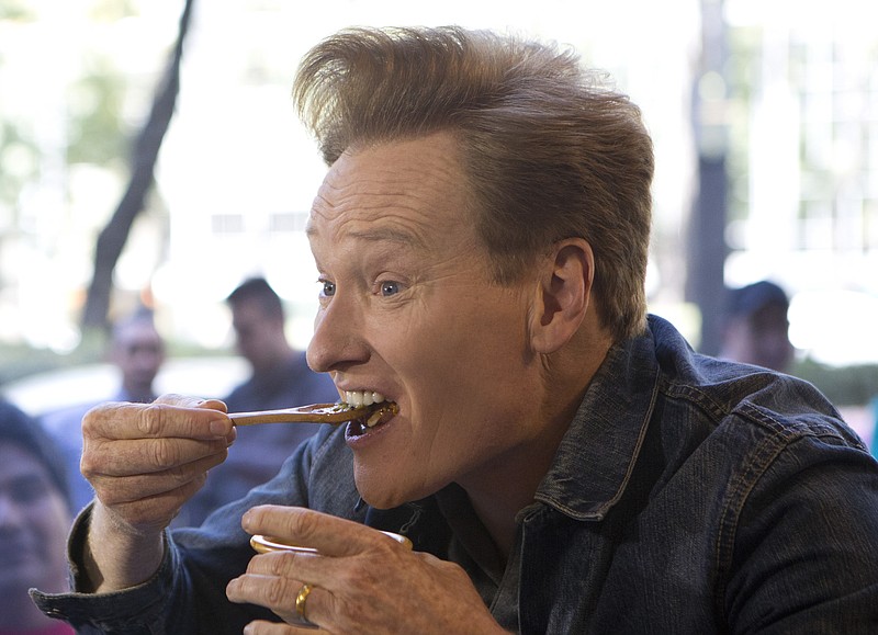 
              Television host Conan O'Brien eats hot sauce straight out of a bowl as he tapes a segment at an upscale taco restaurant in Paseo de la Reforma boulevard in Mexico City, Monday, Feb. 20, 2017. O'Brien is drawing stares in Mexico, where he's taping an episode of his show in a bid to "do something positive" after the tensing of U.S.-Mexico relations. (AP Photo/Rebecca Blackwell)
            