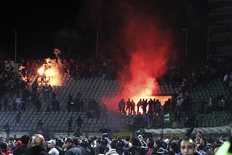 
              FILE - In this Feb. 1, 2012 file photo, Egyptian fans rush onto the field and clash in the stands following an Al-Ahly club soccer match against Al-Masry club at the soccer stadium in Port Said, Egypt. On Monday, Feb. 20, 2017, Egypt's highest appeals court upheld the death sentences against 10 people convicted over a soccer riot in 2012 that killed over 70 fans, becoming one of the world's deadliest soccer disasters. The verdict by the Court of Cassation is final. The defendants were charged with murder along with several other charges. Also, the court also upheld the convictions of 22 suspects who received up to 10 years in prison over the rioting. (AP Photo, File)
            