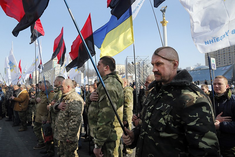 
              Ukrainian army veterans sing the national anthem to pay tribute to the victims of the 2013-2014 anti-government protests called the Revolution of Dignity, during commemoration events in central Kiev, Ukraine, Monday, Feb. 20, 2017. (AP Photo/Efrem Lukatsky)
            