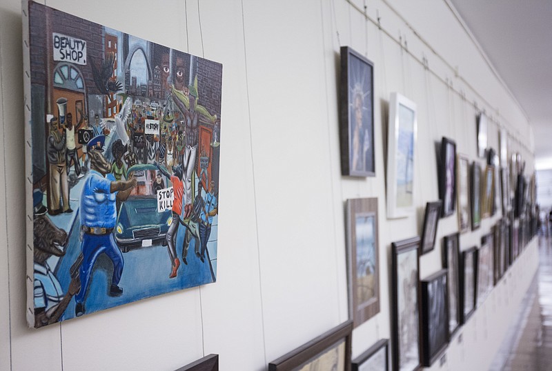 
              FILE - In this Jan. 5, 2017, photo, a painting by David Pulphus is shown hung in a hallway displaying paintings by high school students selected by their member of congress on Capitol Hill in Washington.  The office of Missouri Democratic Rep. William Lacy Clay has announced he intends to file a federal lawsuit Tuesday over the removal of a constituent's painting from its Capitol Hill display.   (AP Photo/Zach Gibson)
            