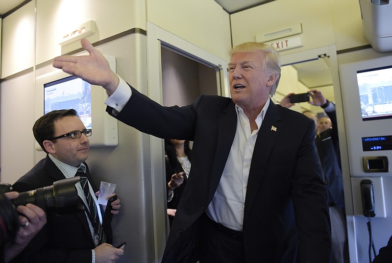 
              President Donald Trump talks to reporters on board Air Force One as he arrived to speak at his "Make America Great Again Rally" at Orlando-Melbourne International Airport in Melbourne, Fla., Saturday, Feb. 18, 2017.  (AP Photo/Susan Walsh)
            