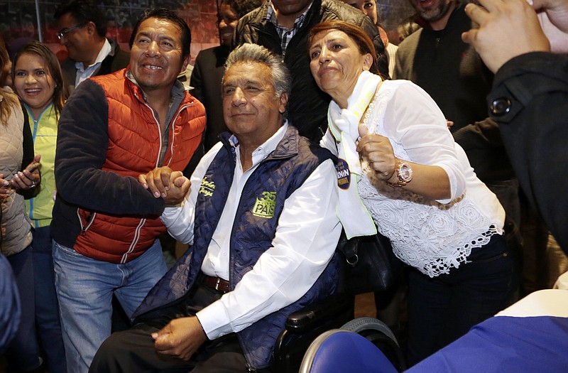 
              Lenin Moreno, presidential candidate for the ruling party Alliance PAIS, center, poses for a photo with supporters after a news conference in Quito, Ecuador, Monday, Feb. 20, 2017. The hand-picked candidate of President Rafael Correa, Moreno held an easy lead Monday in Ecuador's presidential election, though authorities said it might be a few more days before they determine if Moreno won enough votes to avoid a runoff against his nearest rival. (AP Photo/Dolores Ochoa)
            
