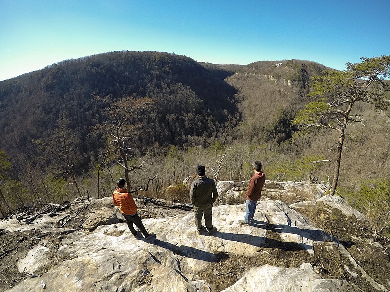In this February file photo, Carpenter Mark Aikers, Cumberland trail Park Ranger Josh Kuykendall and Randy Whorton with Wild Trails, from left, speak about replacing a three-tiered set of stairs which were destroyed during the wildfires that burned segments of the Cumberland Trail last fall. 