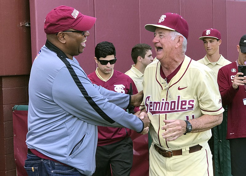 
              Florida State athletic director Stan Wilcox, left, congratulates coach Mike Martin after Martin he got his 1,900th win Sunday, Feb. 19, 2017, in Tallahassee, Fla. Martin is only the second baseball coach in NCAA history to reach that milestone after the Seminoles defeated VCU 11-3, Sunday. (AP Photo/Joseph Reedy
            