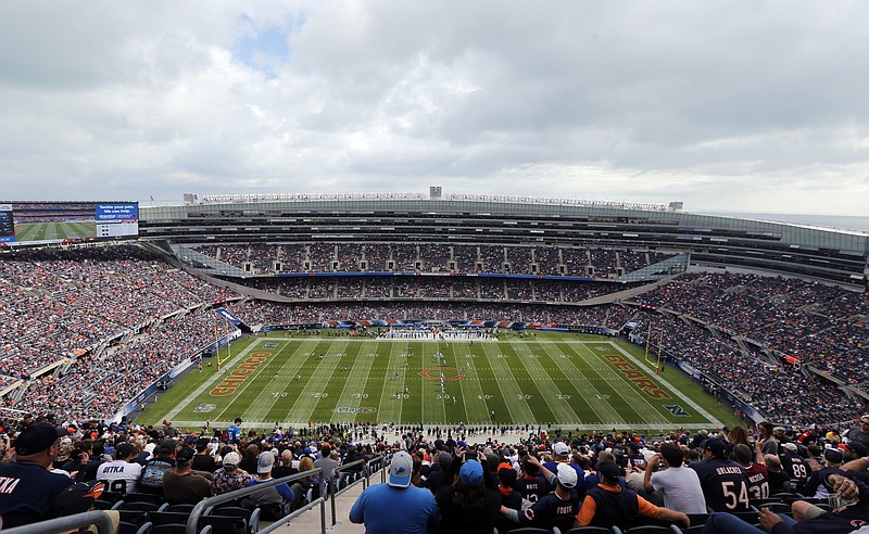 
              FILE - in this Oct. 2, 2016 file photo, fans watch an NFL football game between the Chicago Bears and the Detroit Lions, at Soldier Field in Chicago. The Chicago Bears and the NFL Players Association are at odds over a worker compensation benefit bill in the Illinois Legislature. The bill would decide wether injured pro football players be allowed to earn worker compensation benefits until they are 67 years old, like other workers, even if their athletic careers normally would have ended more than 30 years earlier. (AP Photo/Kiichiro Sato)
            