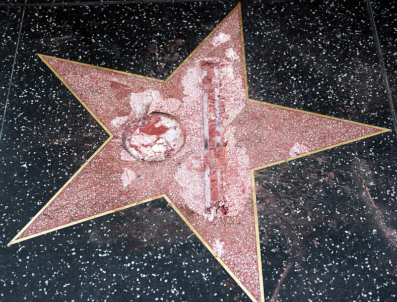 
              FILE - This Oct. 26, 2016 file photo shows the vandalized Hollywood Walk of Fame star of then-presidential candidate Donald Trump. An attorney for James Lambert Otis, who admitted causing the damage, says he pleaded no contest to felony vandalism Tuesday, Feb. 21, 2017. He was sentenced to three years of probation, 20 days of community labor and to pay $4,400 for the damage. (AP Photo/Richard Vogel, File)
            