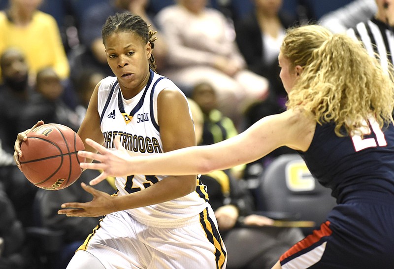 Staff Photo by Robin Rudd UTC's Moses Johnson (23) looks to drive inside of Samford's Katie Allen (21). The Samford Bulldogs visited the UTC Mocs in Southern Conference women's basketball action at McKenzie Arena on February 4, 2017.