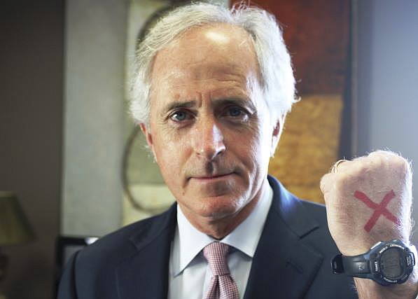 
Sen. Bob Corker, R-Tenn., shows a red "X" on his hand, a symbol calling awareness to the issue of modern slavery, on Feb. in Washington, D.C.