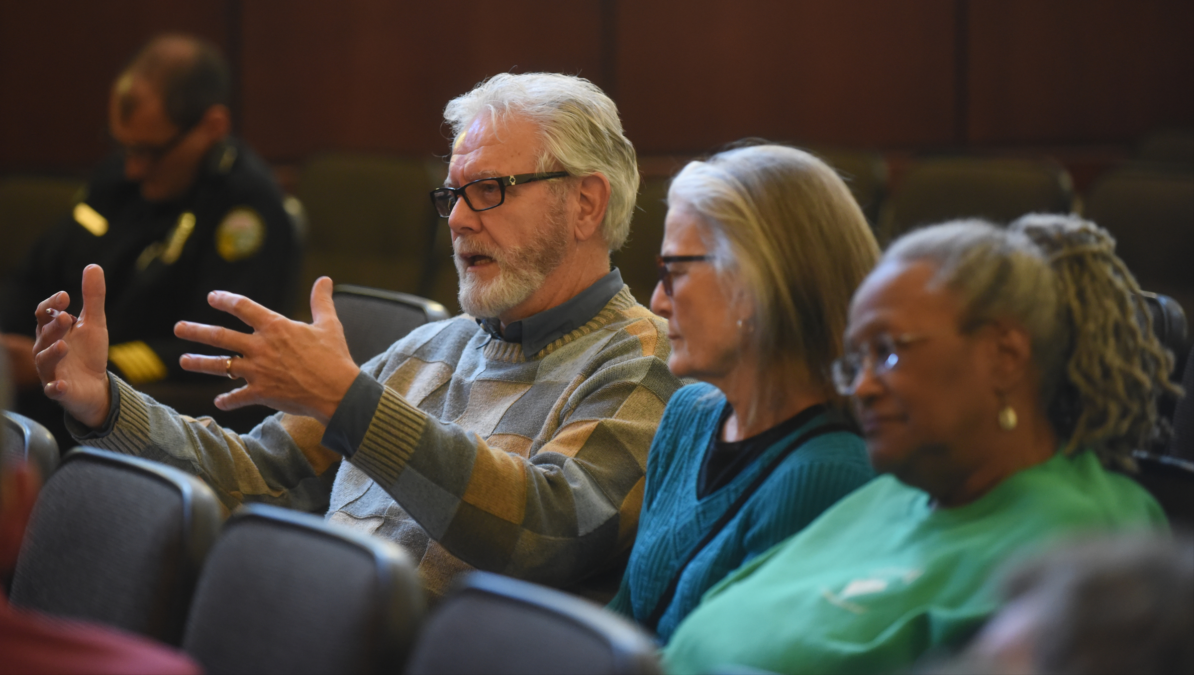 Lloyd Longnion, left, speaks as Jeanette Winn, second from right, and Dr. Everlena Holmes listen at an on-site reaccreditation Monday, March 14, 2016 in the City Council chambers.