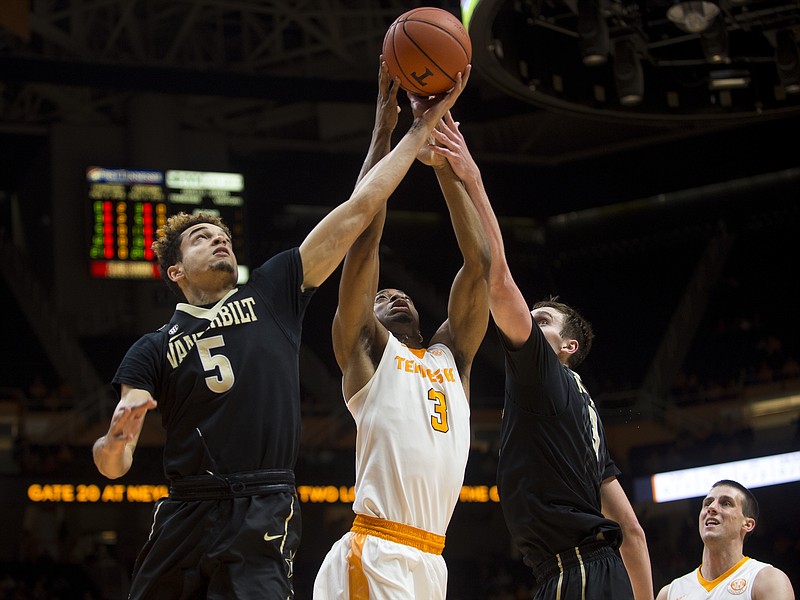 Tennessee's Robert Hubbs III (3) competes for a rebound against Vanderbilt's Matthew Fisher-Davis (5) and Luke Kornet (3) during the first half of an NCAA college basketball game Wednesday, Feb. 22, 2017, in Knoxville, Tenn. (Brianna Paciorka/Knoxville News Sentinel via AP)