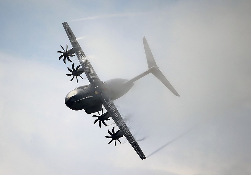 
              FILE - This Thursday, June 20, 2013, file photo shows an Airbus A400M performing its demonstration flight during the 50th Paris Air Show at Le Bourget airport, north of Paris, France. Surprise new costs for the long-troubled Airbus A400M military jet sent the European planemaker's profits plunging last year despite a rise in commercial aircraft deliveries, Airbus reported Wednesday Feb. 22, 2017. (AP Photo/Francois Mori, File)
            