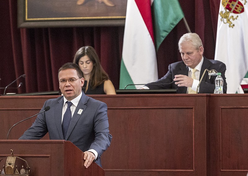 
              Head of the bid of Budapest for hosting the 2024 Summer Olympic Games Balazs Furjes addresses the General Assembly of the City of Budapest with Budapest Mayor Istvan Tarlos, right, and Vice Mayor Alexandra Szalay-Bobrovniczky in the background in the town hall in Budapest, Hungary, Wednesday, Feb. 22, 2017.  (Zsolt Szigetvary/MTI via AP)
            