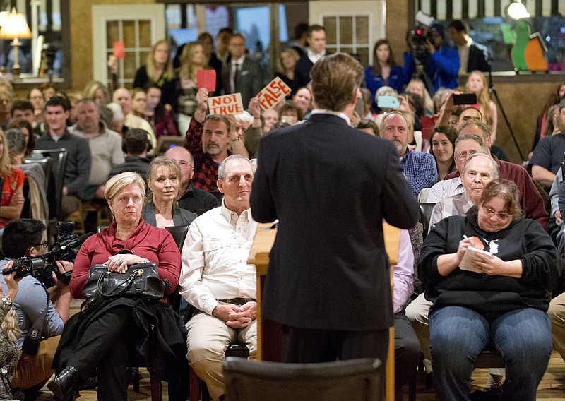 
              Congressman Dave Brat, R-Va., back to camera, answers questions during a town hall meeting with the congressman in Blackstone, Va., Tuesday, Feb. 21, 2017. (AP Photo/Steve Helber)
            