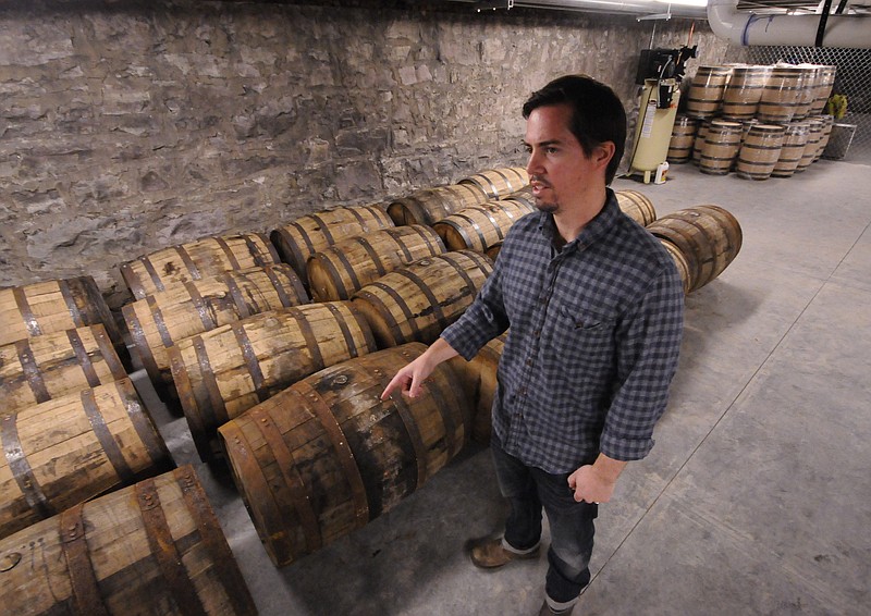 Tim Piersant, owner and co-founder of Tennessee Stillhouse, stands with full barrels of 1816 Chattanooga Whiskey at the company's location on Market Street across from the Choo Choo Hotel.