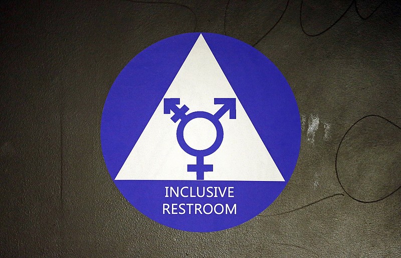 A new sticker designates a gender neutral bathroom at Nathan Hale High School in Seattle. Bathrooms for transgender students have become political footballs again. (AP file photo/Elaine Thompson)