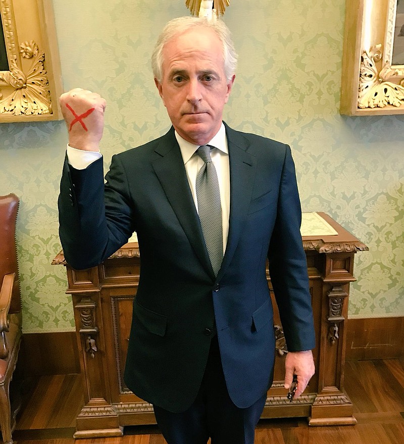 Tennessee Sen. Bob Corker displays a red "X" on his hand that indicates his support of efforts against sex trafficking. This photo was made Thursday at the Vatican.
