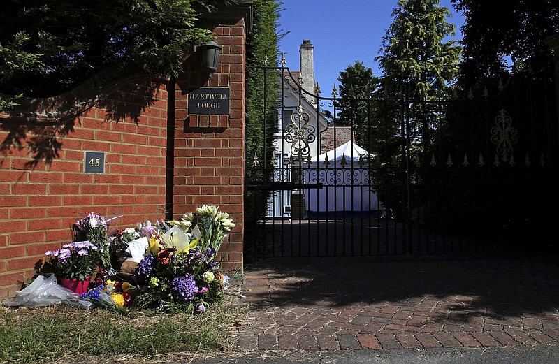 
              FILE - In this file photo dated July 18, 2016, showing tributes left outside the home of children's author Helen Bailey in Royston, England, as police investigations continue at the property.  The jury found Ian Stewart, the partner of Helen Bailey, guilty of killing her and dumping her body in a cesspool at her home, in a financially motivated murder. (Chris Radburn/PA FILE via AP)
            
