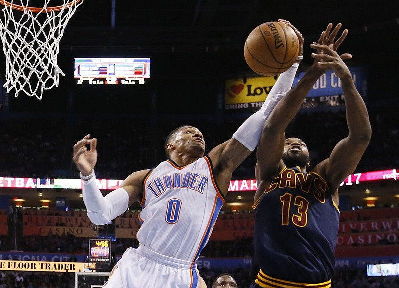 
              FILE - In this Thursday, Feb. 9, 2017, file photo, Oklahoma City Thunder guard Russell Westbrook (0) grabs a rebound in front of Cleveland Cavaliers center Tristan Thompson (13) during the first quarter of an NBA basketball game in Oklahoma City. Larry Bird and Jason Kidd know firsthand the all-around effort it takes to record a triple-double in the natural flow of the game, and they don’t expect Westbrook to back off down the stretch of the regular season that resumes Thursday, Feb. 23, 2017, after the All-Star break. Westbrook is poised to become just the second player to average a triple-double for the season. (AP Photo/Sue Ogrocki, File)
            