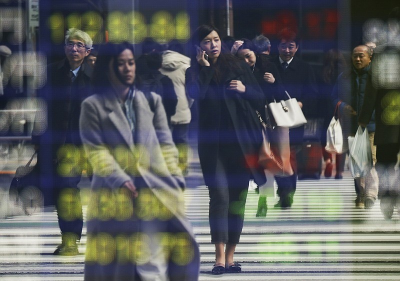 
              People are reflected on the electronic board of a securities firm in Tokyo,Friday, Feb. 24, 2017. Asian markets slipped in muted trading Friday amid worries over U.S. trade policies that may affect regional economies. A stronger yen weighed on Japan's exporters. (AP Photo/Koji Sasahara)
            