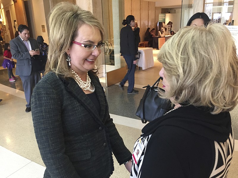
              Former U.S. Congresswoman and mass shooting survivor Gabrielle Giffords, left, greets an admirer at the Statehouse in Santa Fe, N.M., on Wednesday, Feb. 22, 2017. Giffords and her national gun-safety advocacy group Americans for Responsible Solutions are trying to build support for bills that would expand background checks on private firearms sales in New Mexico and remove guns from domestic violence situations where a restraining order has bee issued. (AP Photo/Morgan Lee)
            