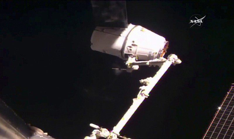 
              SpaceX's Dragon cargo ship is captured by astronauts at the International Space Station on Thursday, Feb. 23, 2017, a day after a GPS problem prevented the capsule from coming too close. (NASA TV via AP)
            