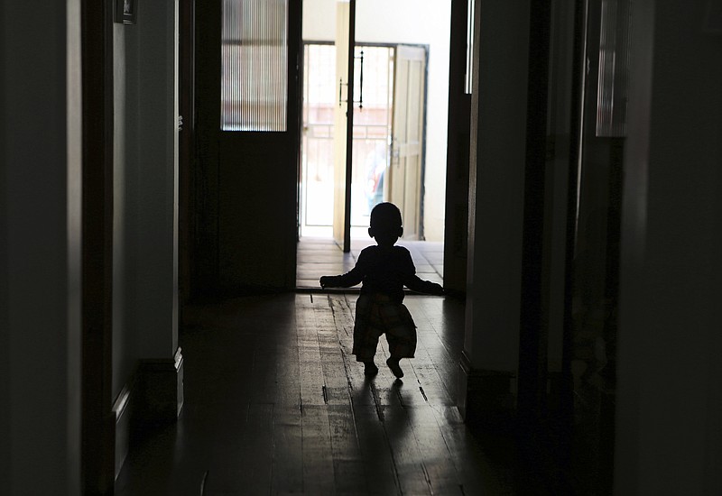 
              In this photo taken Tuesday, Feb. 7, 2017, an abandoned baby walks in a passage at the Door of Hope in Johannesburg. The sanctuary was started 17 years ago to provide a safe place where babies could be abandoned by their mothers. Sixty-four babies were taken in by the center in 2016 and 43 percent of those were adopted. The rest are cared for and eventually go to orphanages, said the organization, which receives funding from the government’s social welfare department and private donations. (AP Photo/Denis Farrell)
            