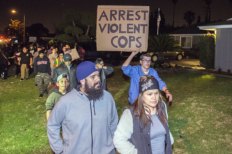 Protesters march towards the off-duty officer's home in Anaheim, Calif., Wednesday, Feb. 22, 2017. A Los Angeles policeman is under investigation after a video appears to show him firing a single round during an off-duty tussle with a 13-year-old boy. No one was injured but two teenagers were arrested after the incident, which spurred dozens of people to protest against police Wednesday night in the streets of Anaheim, where the officer lives and the confrontation occurred. (Joshua Sudock/The Orange County Register via AP)

