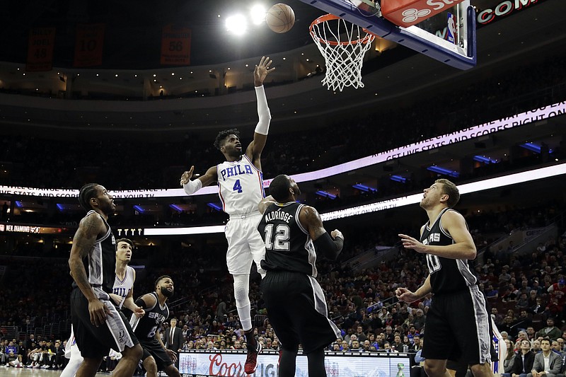 
              FILE - In this Wednesday, Feb. 8, 2017, file photo, Philadelphia 76ers' Nerlens Noel (4) goes up for a shot against San Antonio Spurs' LaMarcus Aldridge (12) during the first half of an NBA basketball game in Philadelphia. A person with knowledge of the deal tells The Associated Press that the Dallas Mavericks have acquired Noel from the Philadelphia 76ers for Andrew Bogut, Justin Anderson and a protected first-round draft pick. The two teams agreed on the deal on Thursday, Feb. 23, 2017, before the trade deadline. (AP Photo/Matt Slocum, File)
            
