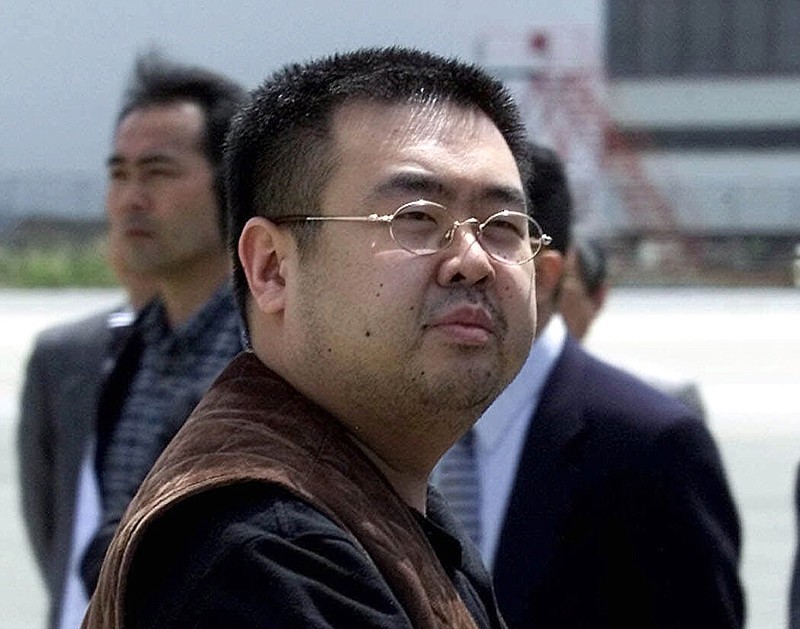 
              FILE - In this May 4, 2001, file photo, a man believed to be Kim Jong Nam, the eldest son of then North Korean leader Kim Jong Il, looks at a battery of photographers as he exits a police van to board a plane to Beijing at Narita international airport in Narita, northeast of Tokyo. Police in Malaysia say the half brother of North Korea's leader who was killed in a Kuala Lumpur airport more than a week ago had a nerve agent on his eye and his face. A statement Friday, Feb. 24, 2017 from the inspector general of police said that a preliminary analysis from the Chemistry Department of Malaysia identified the agent at "VX NERVE AGENT." (AP Photo/Shizuo Kambayashi, File)
            