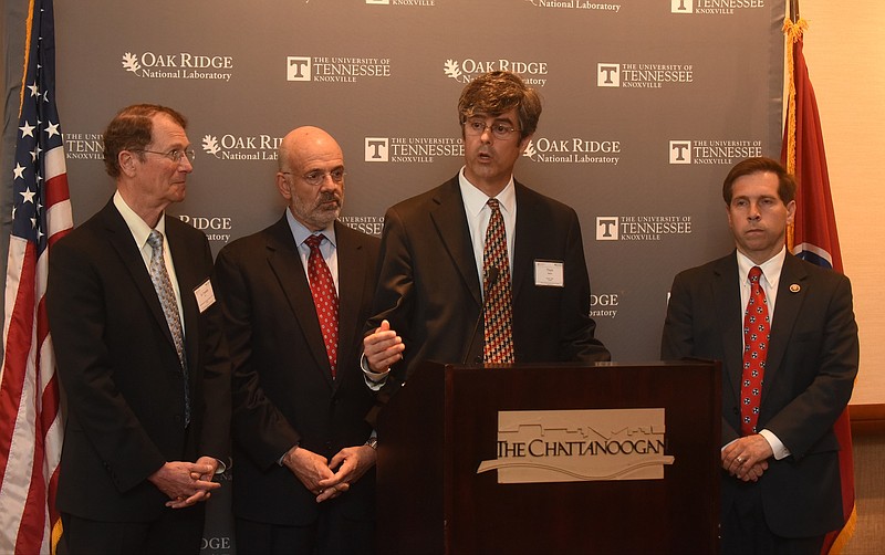 Thom Mason speaks as Dr. Franklin Orr, University of Tennessee President Joe DiPietro and Chuck Fleischmann, R-Tenn., from left, listen during a press conference at a regional energy innovation conference May 23, 2016, at the Chattanoogan.