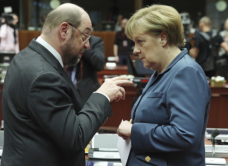 
              FILE - In this Dec. 19, 2013 photo then European Parliament President Martin Schulz, left, talks with German Chancellor Angela Merkel, during an EU summit at the European Council building in Brussels. A new poll published Friday, Feb. 24, 2017 shows Germany's center-left Social Democrats nudging past Chancellor Angela Merkel's conservative bloc in support for the first time in more than a decade. (AP Photo/Yves Logghe, file)
            